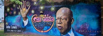 Colorful mural of civil rights leader John Lewis that says good trouble.